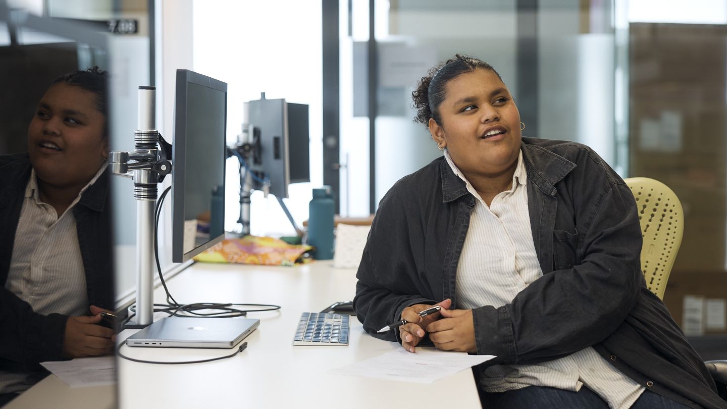 Apprentice sitting at a computer